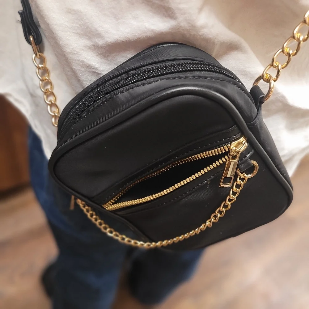Elegant Black Crossbody Bag with Gold Accents